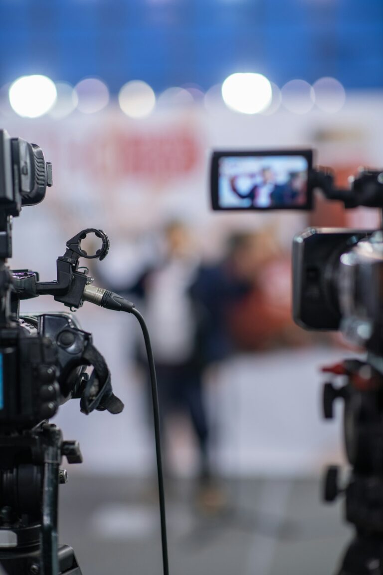 Close up view of a camera capturing the essence of a press conference, revealing intricate details