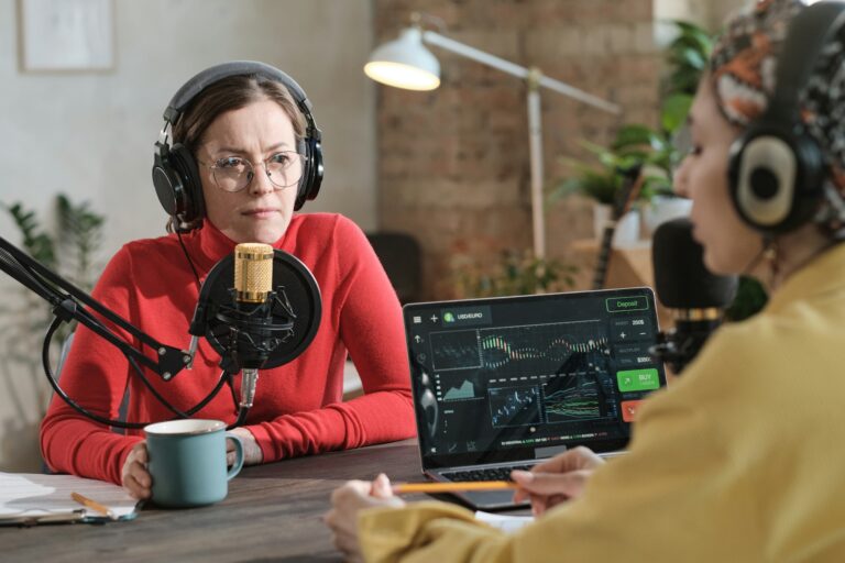 Two women podcasters in headphones recording content