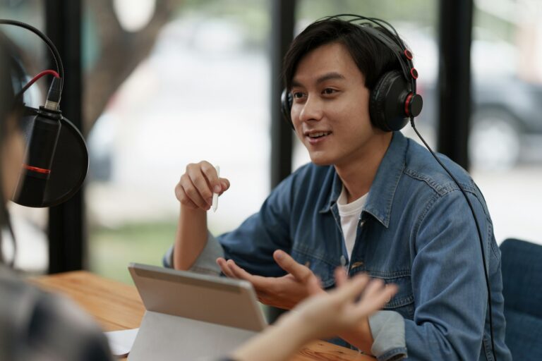 Podcaster making audio podcast working with guest at home studio